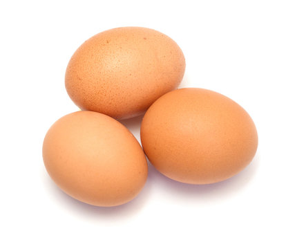 Three chicken eggs on white background