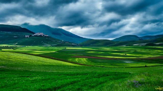 Dusk green mountains at spring, Castelluccio, Italy