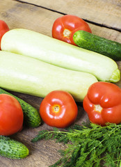 fresh vegetables, squash, cucumbers, tomatoes and fennel on wooden background