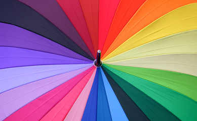 Close up of a rainbow colored umbrella.   © Passakorn