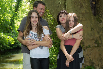 Happy young family with two children outdoors