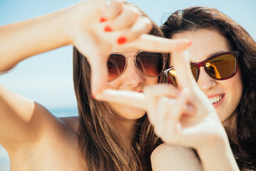 Female friends framing with hands