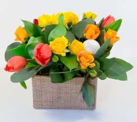 Composition. Box of yellow roses and tulips