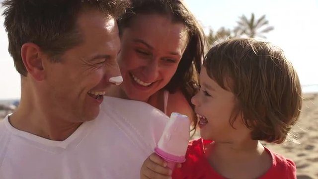 Family Eating Popsicles At The Beach.