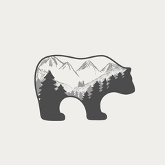 Silhouette bear spruce forest and mountains