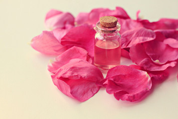 Obraz na płótnie Canvas rose fragrance corked bottle pink flower petals aromatherapy vintage romantic edit