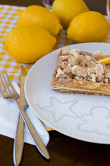 Waffles with meringue, lemon curls and orange slices 