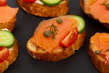Finger food canapes with smoked salmon and cream cheese. Selective focus.