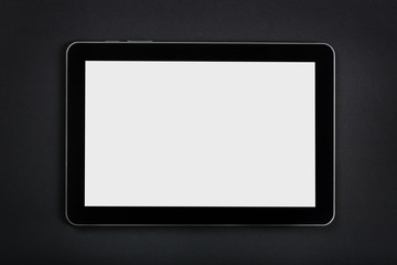 Tablet on dark desk.