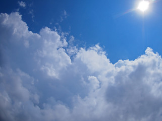 Dark clouds, blue sky and bright sun