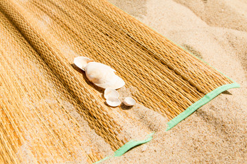 Matting on sand with shells