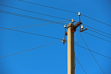 Power transmission lines against blue sky