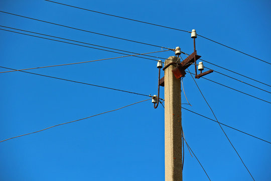 Power transmission lines against blue sky