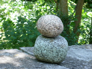 Fototapeta na wymiar superimposed stones on a crack, in a garden
