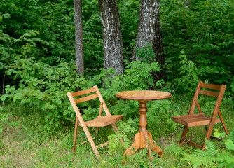 Table and chairs in the woods