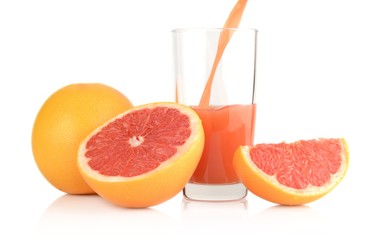 Studio shot sliced grapefruits with poured juice on white