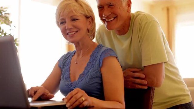 senior couple using laptop computer