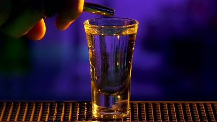 Bartender continue making, pouring cocktail with white alcohol