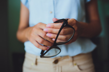 Human hands woman holding eyeglasses