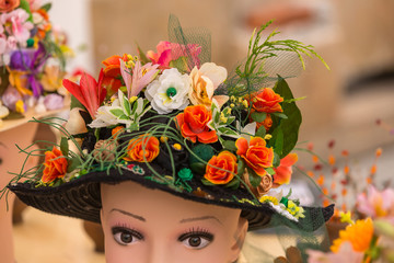 Hat with natural and artificial spring flowers