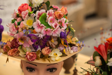 Hat with natural and artificial spring flowers