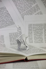 Origami dinosaur coming out of a book