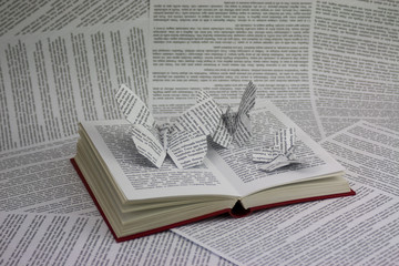 Origami butterflies coming out of a book
