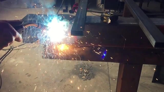 Welder at work in industrial environment, slow motion
