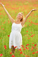 happy pregnant woman in poppie field