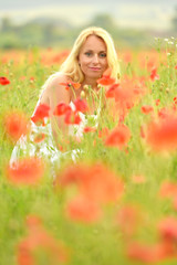 happy pregnant woman in poppie field