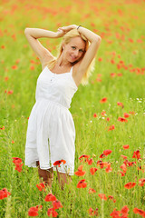 happy pregnant woman in poppie field