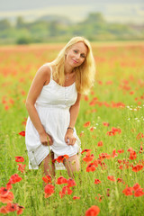 happy pregnant woman in poppie field