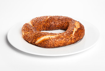 Simit (Turkish bagel) on white plate