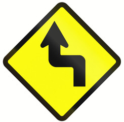 Indonesian road warning sign: Reverse turn