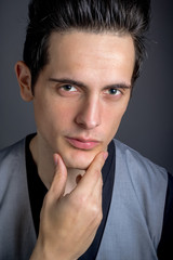 Dark Hair Green Eye Male With Hand On Chin