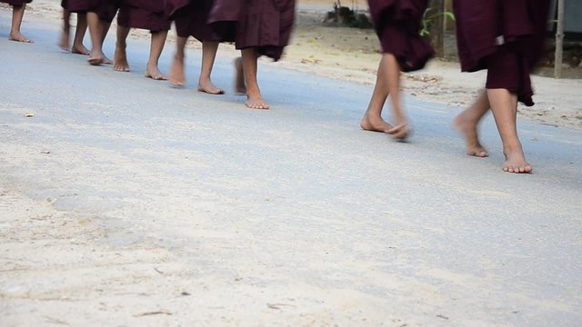 Feet of Monk procession walking on the road for people pray