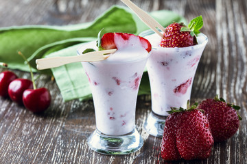 Frozen fruit smoothies with fresh strawberries on top