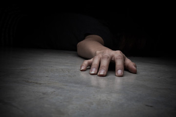 The dead woman's body. Focus on hand