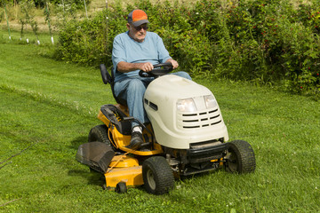 Older Gentleman Cutting Gas On Riding Lawnmower