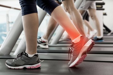 Fototapeta na wymiar Highlighted ankle of woman on treadmill
