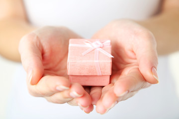 Female hands holding gift box