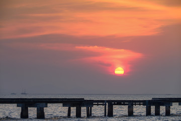 Obraz premium bridge to the sea with Sunset background