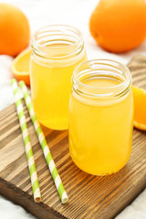 Orange juice in bottle on cutting board