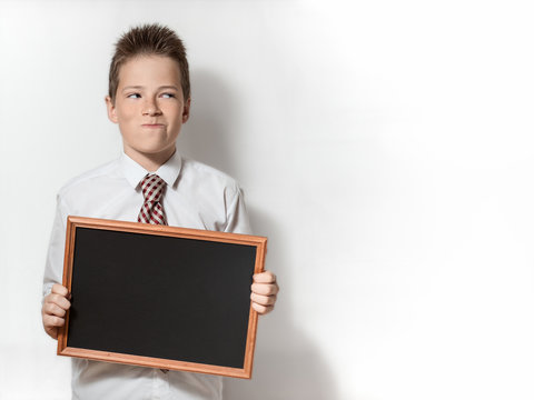 Pawky boy with empty chalkboard