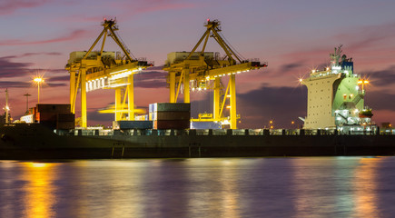 Container Cargo freight ship with working crane loading bridge i