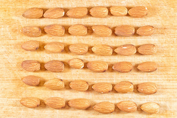 Almonds lie on a wooden table