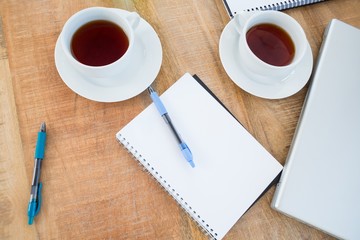 Overhead of coffee and notebook on the desk 
