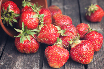 Ripe strawberries on dark wood