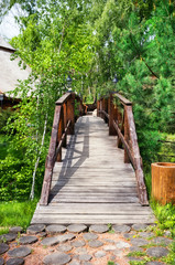 Fototapeta na wymiar Wooden bridge over the ravine