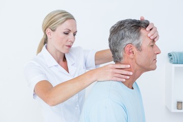 Doctor doing neck adjustment